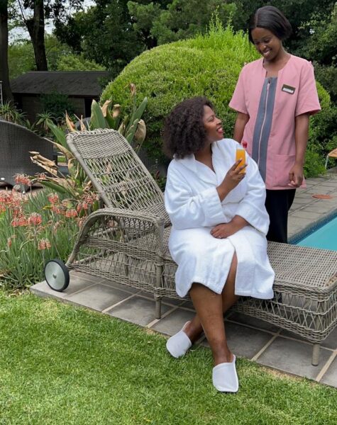 A picture of a massage therapist smiling with a client